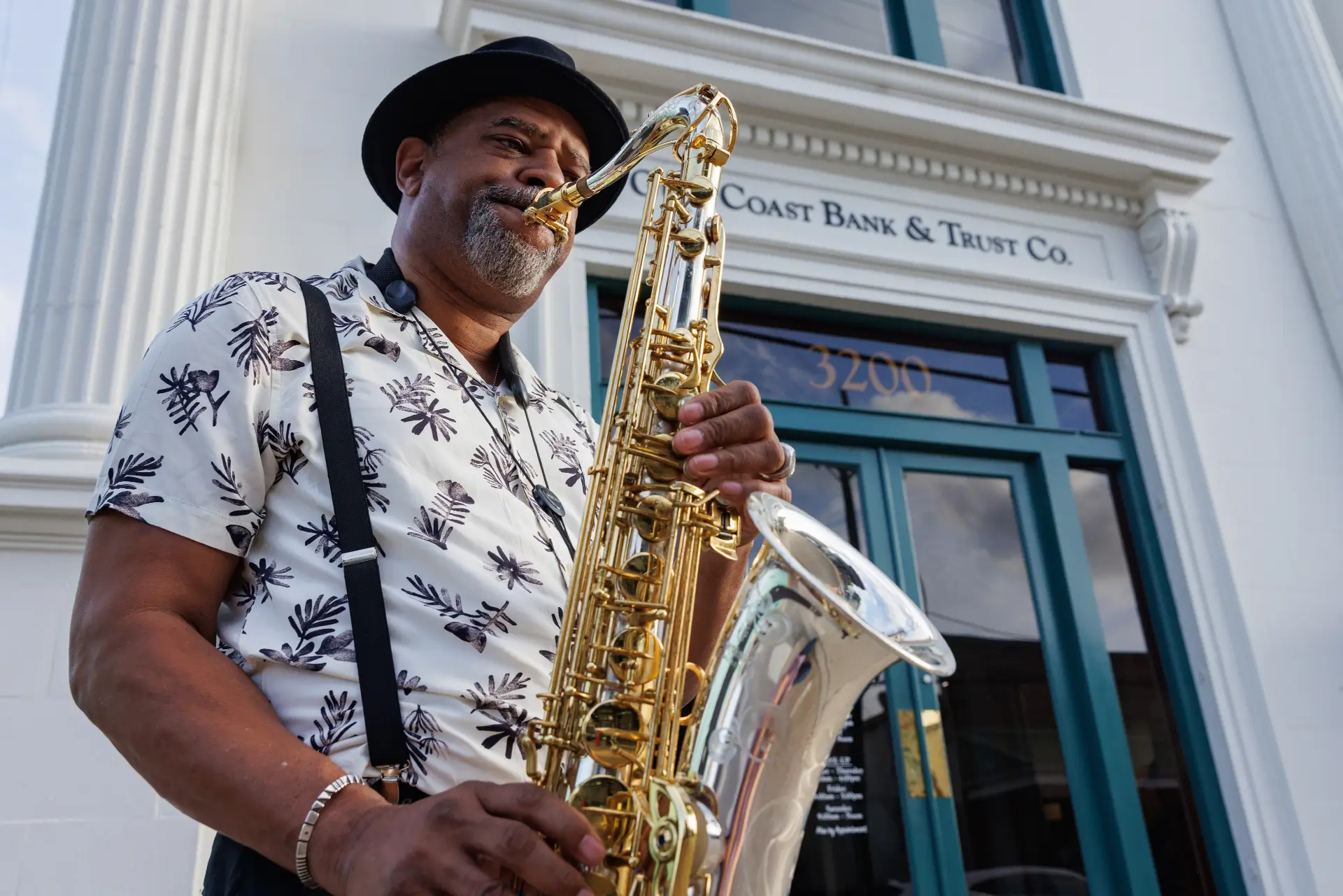 Saxophone plays outside of bank opening